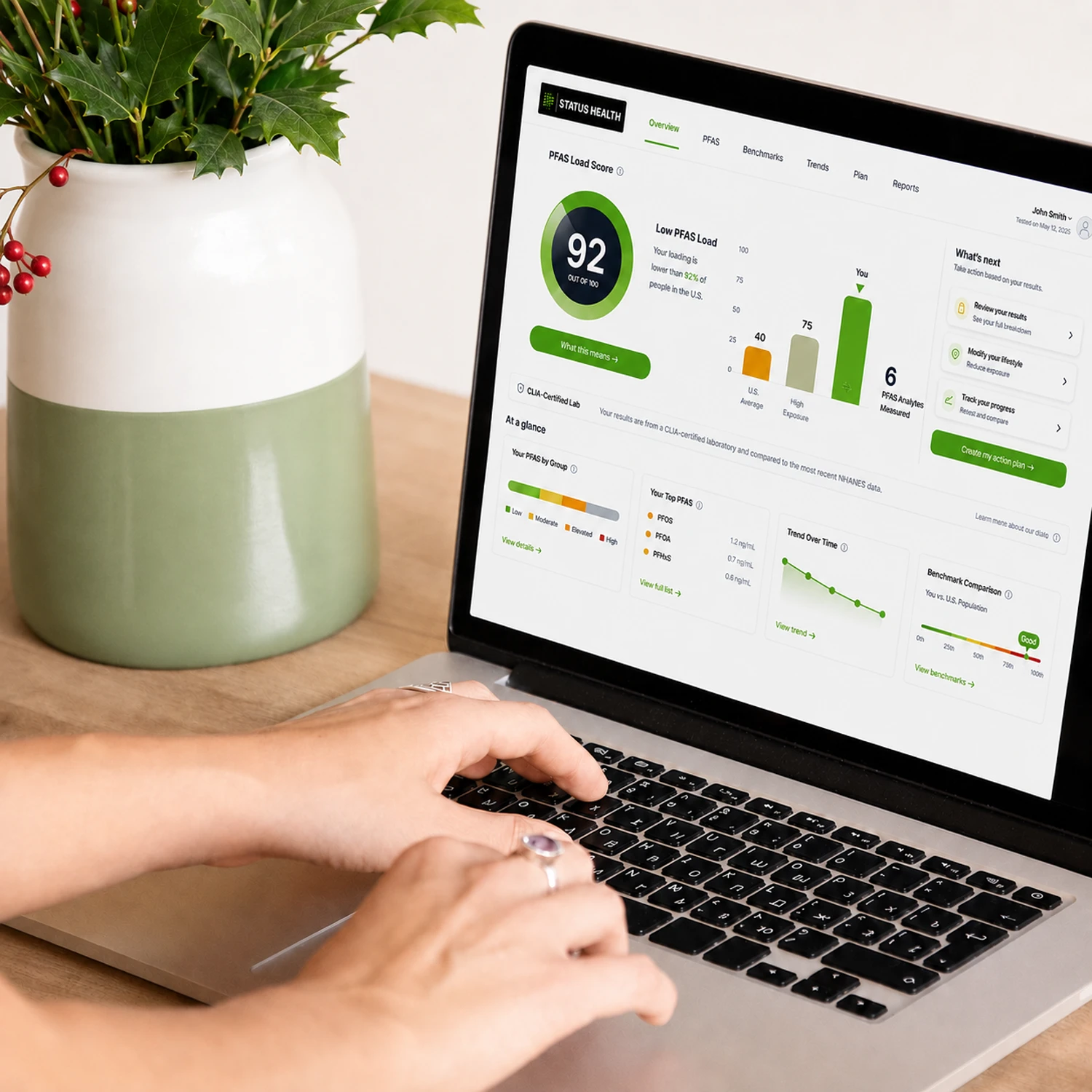 The Status Health results dashboard open on a laptop